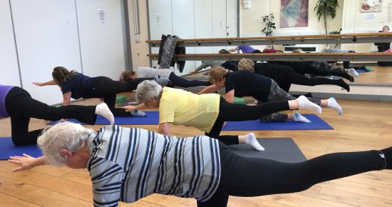 Picture of Pilates class conduct the Superman exercise